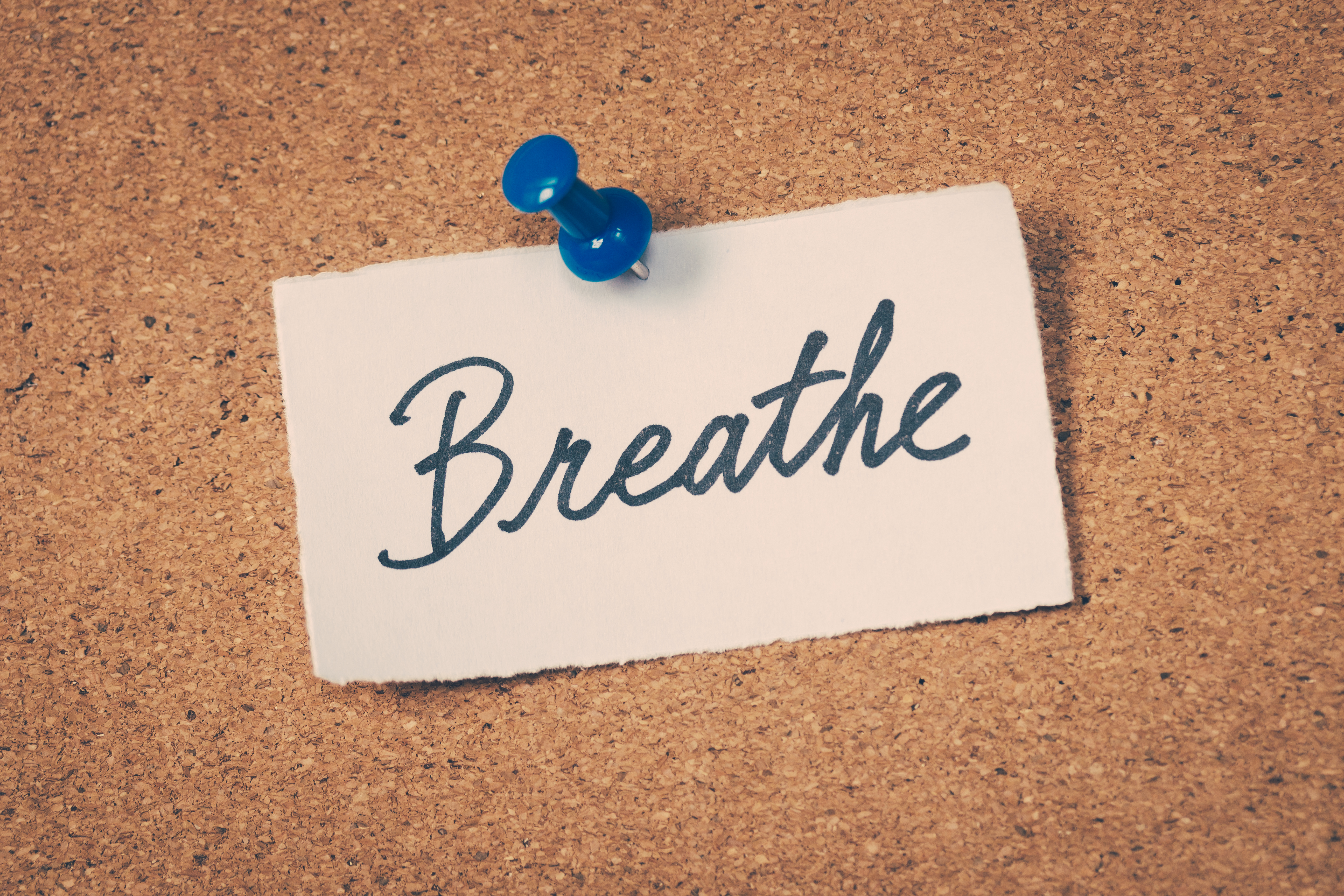 Corkboard reminder to breathe to ease anxiety and stress