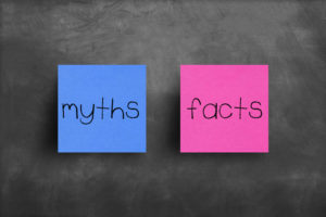 Two sticky notes on a blackboard; "myths" and "facts"